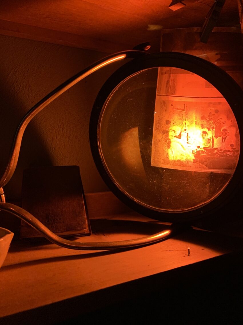 Red darkroom light glowing.