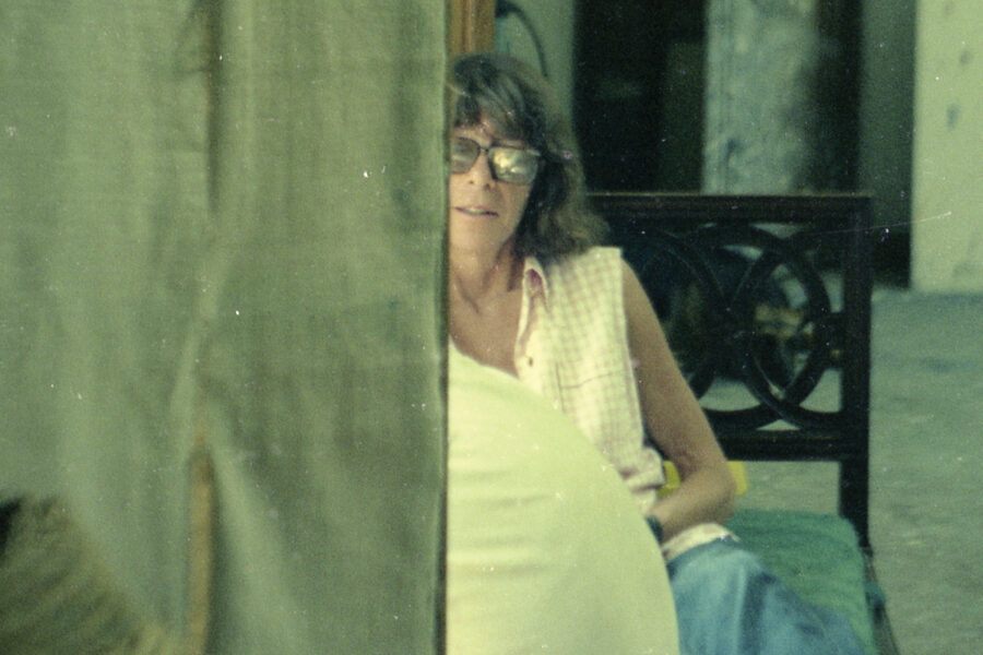 Sepia toned photograph showing painter Joan Mitchell behind a canvas in her studio