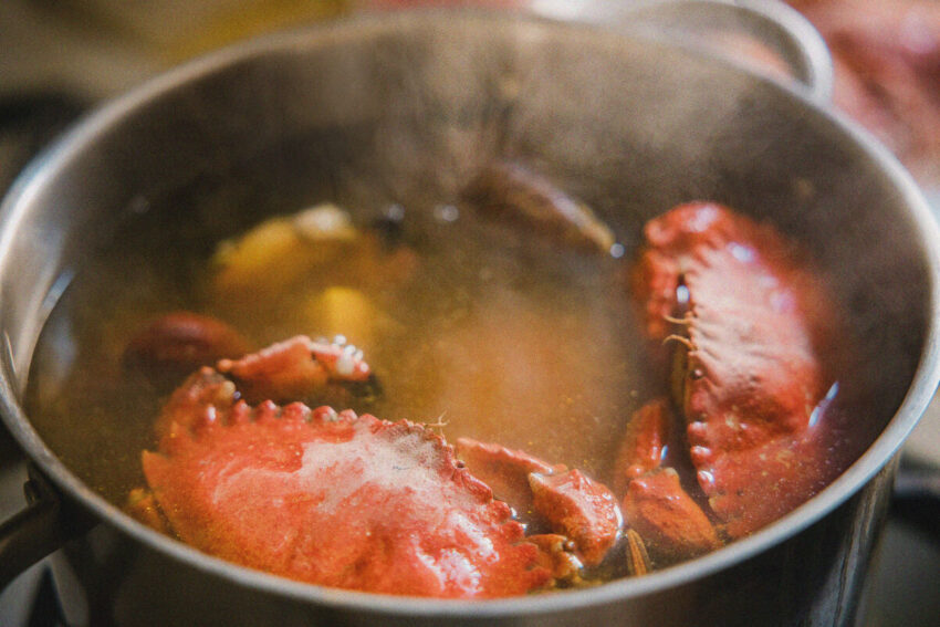 Crabs cooking in a pot of steaming water