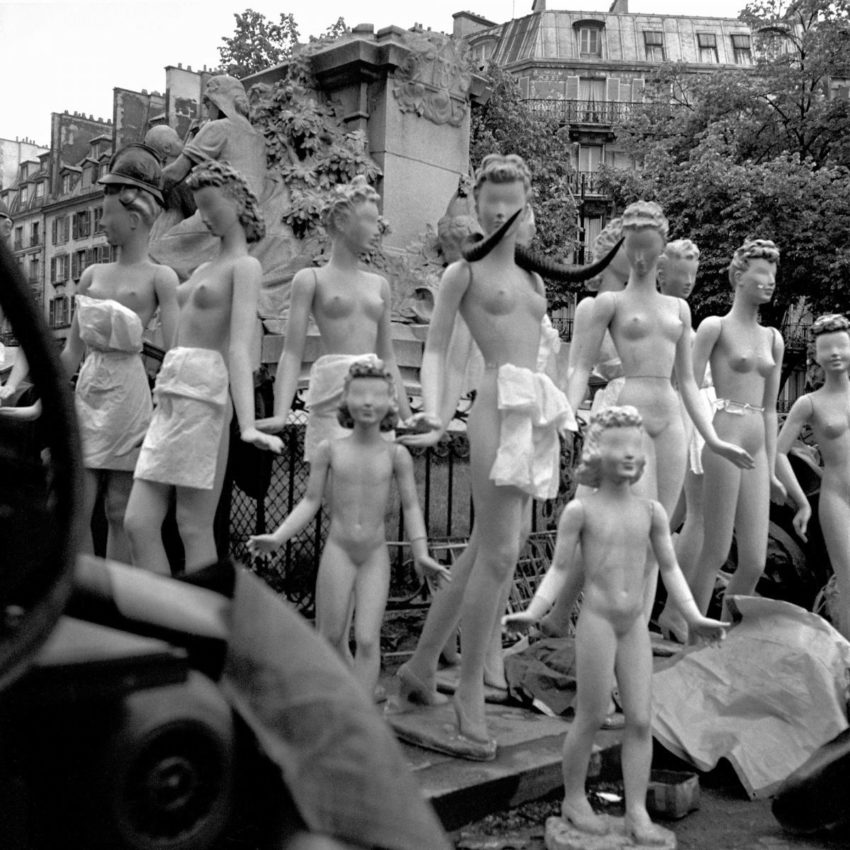 black and white photo of a cluster of mannequins standing together