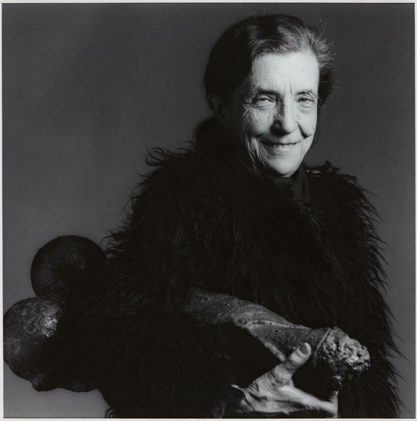 Black and white portrait of Louise Bourgeois holding Filette.