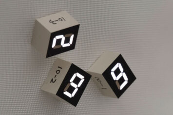 Digital blocks depicting the numbers two, nine, and nine in an art installation by Tatsuo Miyajima