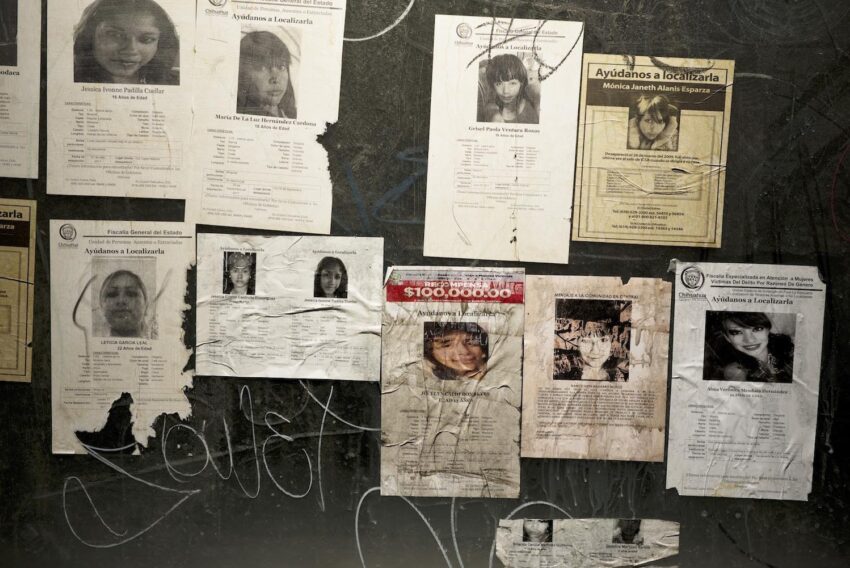 Installation view with missing person photos.