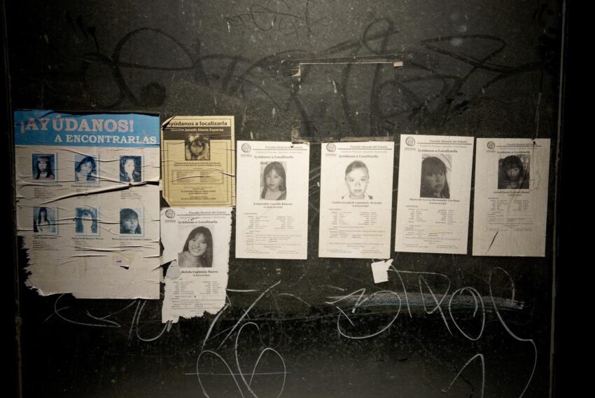 Installation view with missing person photos.