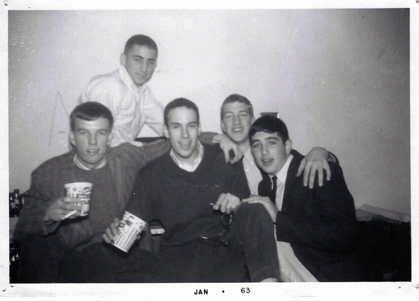 Black-and-white yearbook photo showing David Lynch and Bill Frazier sitting with a group of friends at a fraternity party.