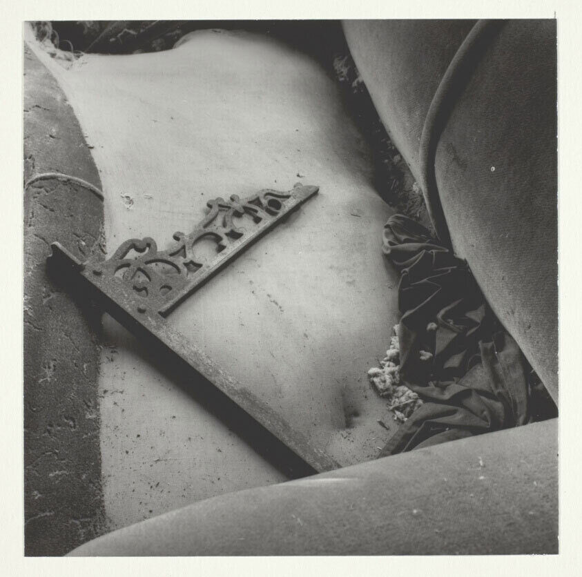 Dick Rudisill’s “Ruined Couch,” a gelatin silver print of a cushionless, dirt-covered sofa